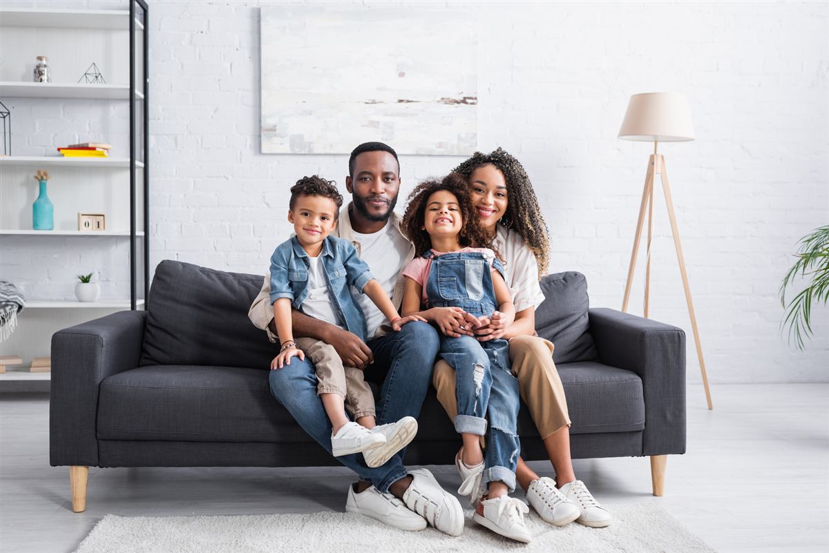 A family relaxing together on a couch at home